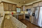 All stainless kitchen with warm tones welcomes you